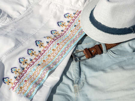 Flat lay fashion women summer beachwear accessories: shorts, shirt, hat, belt. Travel vacation background. Top viewの写真素材