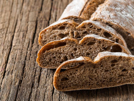 Ciabatta. Dark fresh healthy flattish open-textured Italian bread with a floury crust made with...