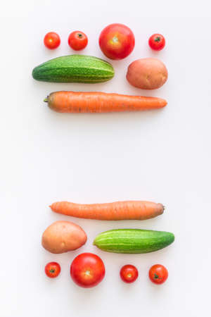 Fresh farm vegetarian and vegan vegetables on white background. Healthy food supermarket banner. Zero waste concept. Frame layout flat lay. Top viewの写真素材