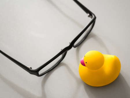 Toy yellow rubber duck on the desktop. Opposition symbol and political struggle.の写真素材