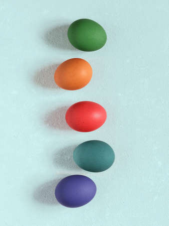 Colored chicken easter eggs on a pastel blue background. Happy easter concept. Minimalism. Top view. Copy spaceの写真素材