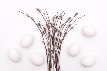 A bouquet of flowering branches on a white background. Blooming buds and white eggs. Easter concept. Festive spring cardの写真素材