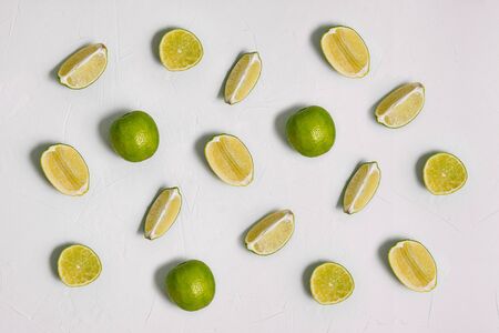 Lime on a white background. Slices of fresh citrus fruits are arranged in a row. Cooking, recipes,...