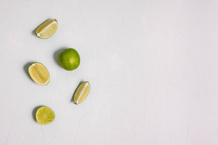 Juicy lime cut into pieces. Green lime fruit on white background. Ingredient for the preparation of...