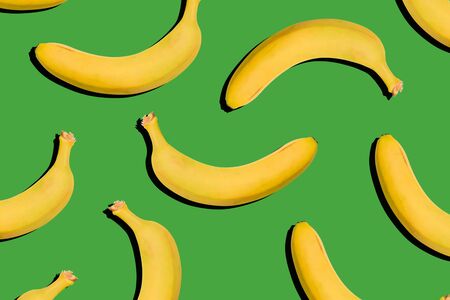 Bananas on a green background. Healthy food, nutrition concept. Creative style, modern artの写真素材