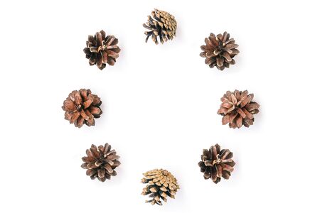 Circle of pine cones on a white background. Natural christmas composition. Holiday card. Flat lay....