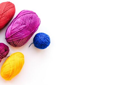 Materials to do the work at home. Multi-colored bandaged threads for needlework. View from above....