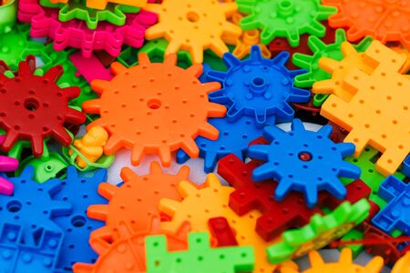 The children's designer. Colored plastic blocks of the designer on the table. Children's designer for the development of motor skills, thinking and imaginationの写真素材