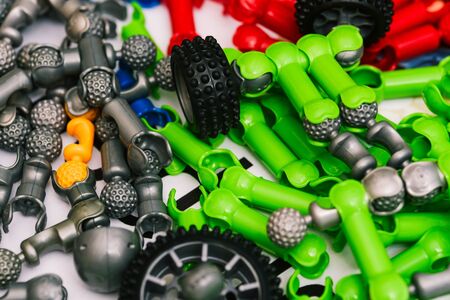 Gray and green details of the designer for the construction of a toy car. Constructor blocks for the game. Modeling at school. The development of creativity and imagination in a child.の写真素材