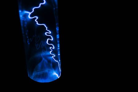 Lightning blue on a black background. Natural magic light effect. Abstract electric shock. Energy and Physicsの写真素材
