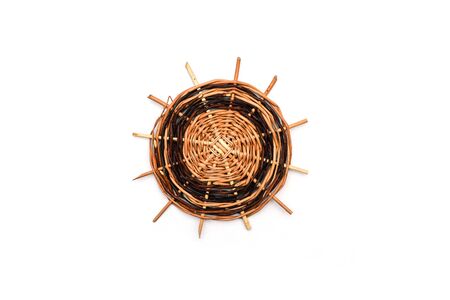 Wicker stand for hot food in the kitchen from juniper. Brown decorative rug for a teapot, tea or...