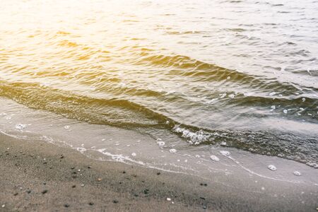 Sand beach and shore wave texture. Wave on the sandy beach