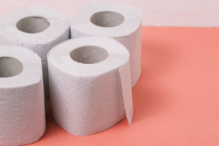 Toilet paper on a pink background with copy space. Sanitary and household suppliesの写真素材