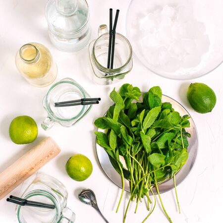 Ingredients for making mojito. Top view with copy space. Cooking mojito. Lime, mint, empty cocktail glass jars and rum.の写真素材