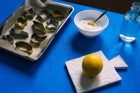 Making sugar candies at home. Empty metal tins for candy cans, sugar and lemon.