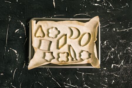 Making candy. Empty metal forms in a baking sheet not against a black background. Homemade sweet candies.の写真素材