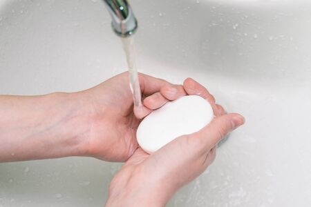 Hand washing in a sink with soap. Cleansing the skin of dirt, bacteria and viruses. Antibacterial agent for infectionsの写真素材