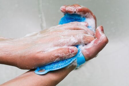 Hand washing with soap. White foam with bubbles on hands. The procedure for cleaning hands from dirt, germs and bacteria. Coronavirus Prevention.の写真素材