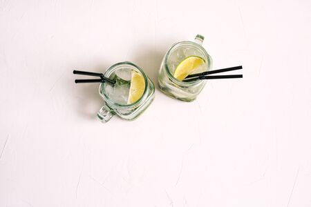 Two glass glasses with mojito summer cocktail. Refreshing alcoholic cocktail on a white backgroundの写真素材