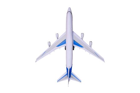 Model airplane on a white background. Toy airplane, top view. Passenger liner for flying around the world. Travel and tourismの写真素材