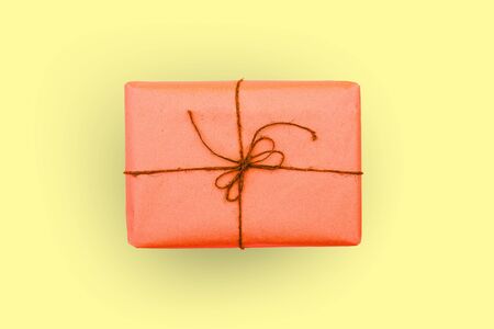Box of red on a yellow background. Gift or packageの写真素材