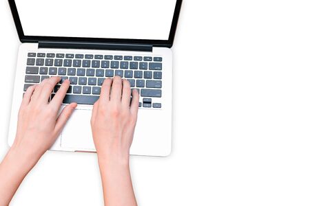 The girl works on the computer. Laptop isolated on a white background. Hands are typing on the keyboard. The concept of remote workの写真素材