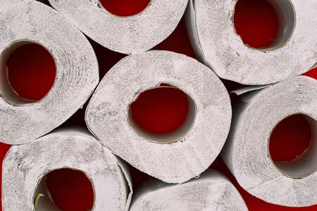 Rolls of toilet paper on a red background. Top view, flat layの写真素材