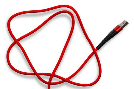 Red usb cable for phone and tablet on a white background. Communication concept, technology, accessories for cell phones, recharge, data transfer.の写真素材