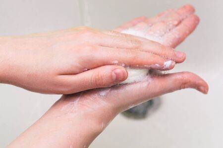 Personal hygiene, prevention of diseases and infections. Hand washing with soap and water to prevent coronavirusの写真素材