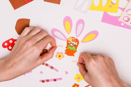 Woman makes applique on a white table. Idea for children's creativity, art project. Crafts for childrenの写真素材