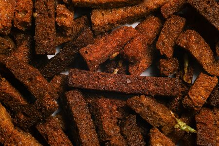 Salty croutons of brown bread with garlic and salt. Fried croutons closeup. Beer snackの写真素材