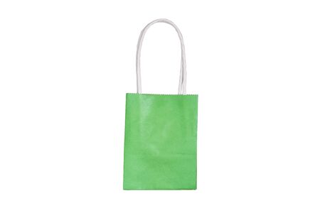 Small green paper bag isolated on a white background. Food delivery from a store or restaurant. Food and shopping takeaway conceptの写真素材