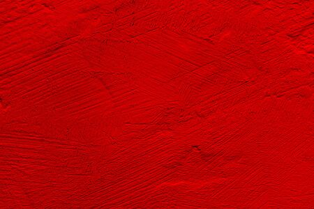 Red background with a textured surface. Abstract bright background.