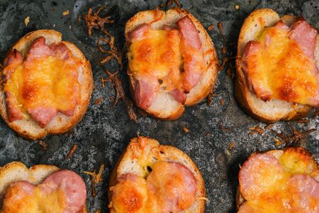 Baked sandwiches with sausage and cheese. Close-up of prepared small sandwiches.の写真素材