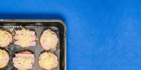 Cheese and ham sandwiches. Preparing fast food and snacks for the party. Top view, copy space.の写真素材