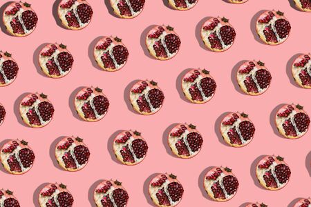 Red garnet on a pink background. Fashion seamless models. Fruit template.の写真素材