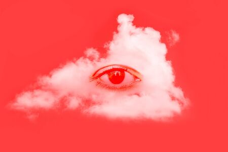 Human eye and a white fluffy cloud on a red background. Creative minimal concept. Modern art, collageの写真素材