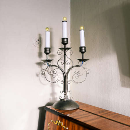 Vintage lamp with light bulbs stands on the piano. Decorative element of the interior. The design element of the room.の写真素材