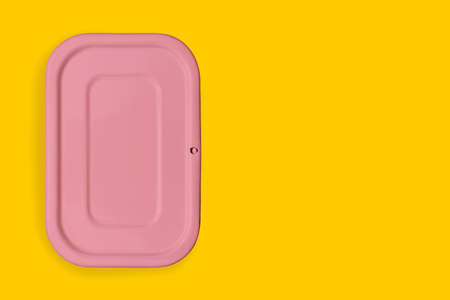 Pink food container on a colored background. Packaging for storing Breakfast, dinner or lunch. The concept of food delivery. Top view, copy spaceの写真素材