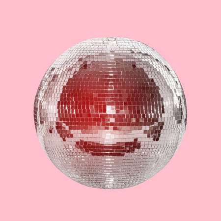 Mirror ball on a pink background with a red tint. Concept of entertainment, party and night life. Disco ballの写真素材