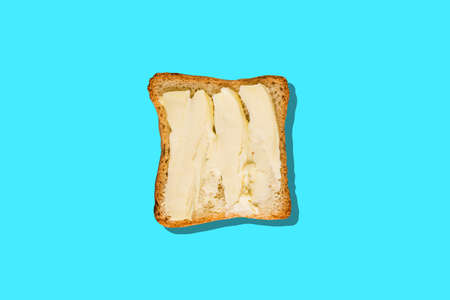 Tasty toasted bread with banana and peanut butter on color backgroundの写真素材