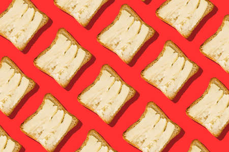 Butter and bread on a red background. Creative minimal style.の写真素材