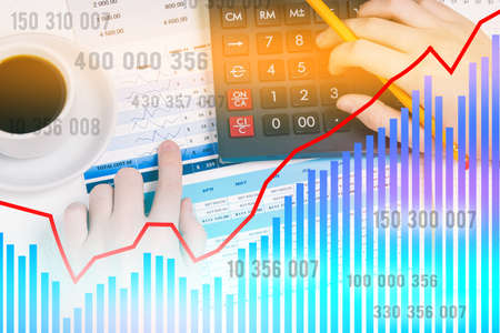Calculator and hands with a pencil. A person calculates on a calculator and analyzes the data. Financial chart with numbersの写真素材