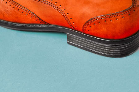 The heel of mens shoes on a colored background close-up. Mens shoes. Shoe sales. Stylish accessory made of genuine leather. Side view with a copy of the spaceの写真素材
