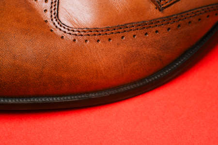 Part of mens shoes close-up. Genuine leather texture. Side view with a copy of the space