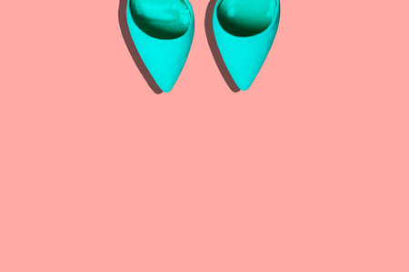 Turquoise women high-heeled shoes on a pastel pink background. Fashionable womens colored background. top view of a flat layout. Fashion blogの写真素材