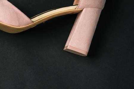 Womens high-heeled shoes on a black background. The heel of a beige Shoe. Close-up with a copy of the spaceの写真素材