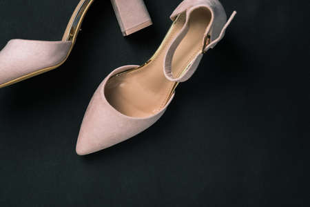 Stylish womens high-heeled shoes close-up. Womens shoes on a black background with a copy of the space. Delivery and sale of womens accessoriesの写真素材