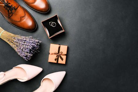 Wedding background with rings in a box, a bouquet of lavender flowers and shoes. The details of the wedding. Top view with a copy of the space.の写真素材