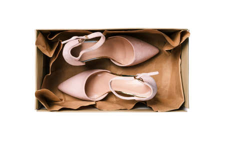 Box with womens shoes, isolated on a white background. Womens fashionable and stylish shoes are in an open box without a lid. The concept of delivering things and selling goods in the storeの写真素材